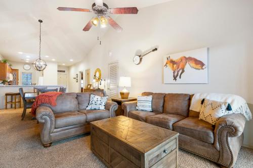a living room with two couches and a table at Whippoorwill Woods - 3 BDR with Tons of Amenities in Branson West