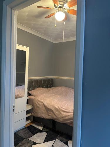 a bedroom with a bed and a ceiling fan at Double room in a shared house in Chatham
