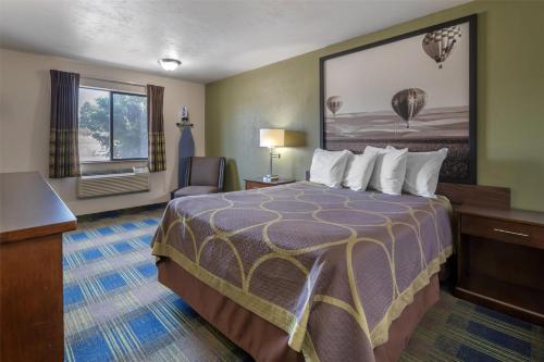 a hotel room with a bed and a desk at SureStay by Best Western Walla Walla in Walla Walla
