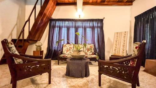 a living room with two chairs and a table at RIVINSON Villa Beruwala in Beruwala
