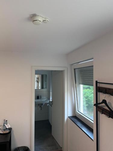 a bathroom with a sink and a window in a room at Café und Restaurant Schlossblick in Kirchberg an der Jagst
