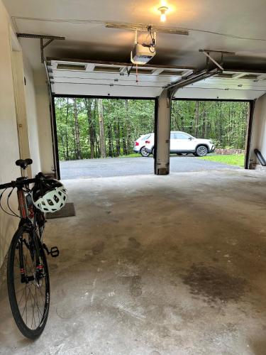 a bike parked in a garage with a parking lot at Nature's Nest - Woodland Retreat - Fireplace - Quiet and Cozy in Bethlehem