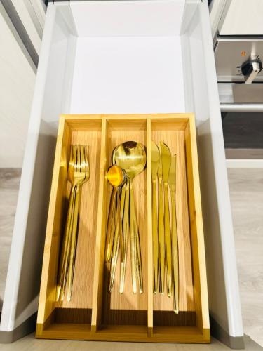 a wooden box filled with forks and spoons and forks at Bright & Cozy 1 Bedroom Retreat in Vaughan