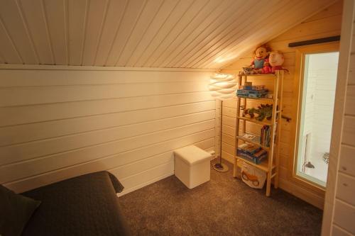 a corner of a room with a lamp and a shelf at 2-Wing Villa 4BR, 2 SkiPasses, Ylläs & Nature View in Ylläsjärvi