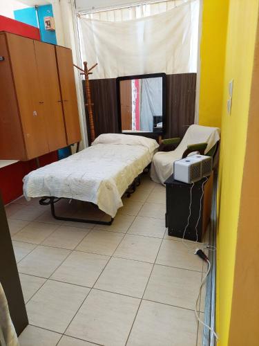 a room with two beds and a tv in it at Charming Studio in Amaliada, Greece with Private Entrance in Amaliás