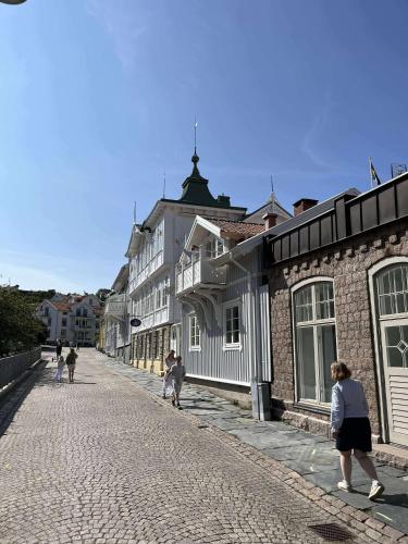a group of people walking down a cobblestone street at Marstrand in Marstrand