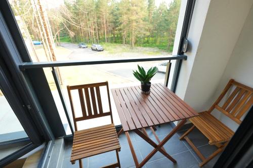 two chairs and a table in front of a window at Green Hill Susic in Divčibare