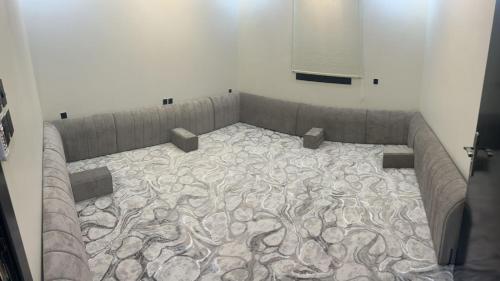 a couch in a room with a painting on the wall at شقق روابي الباحه in Al Jith