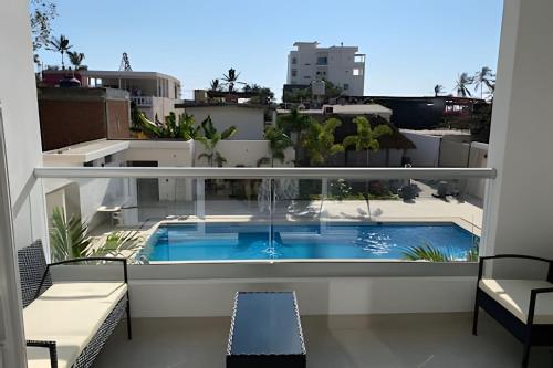 a balcony with a swimming pool on top of a building at Costa Paraíso D-9 Estudio in Bucerías
