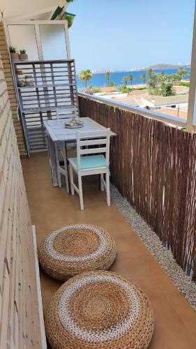 a patio with a table and a chair on a balcony at Amanecer en Cristal in Cartagena