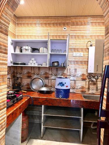 a kitchen with a wooden counter top with a sink at PARADISE VILLA "Lord Krishna's Inn" in Vrindāvan