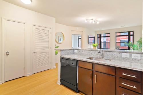 a kitchen with a sink and a counter top at Comfort & Convenience in Trendy Crystal City Loft in Arlington