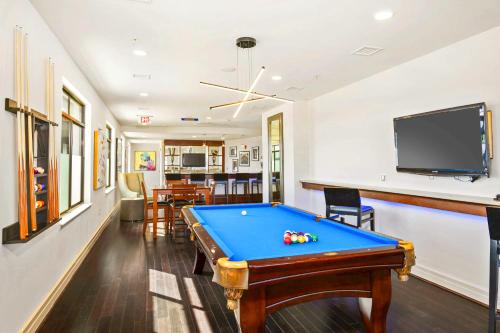 a living room with a pool table and a tv at Comfort & Convenience in Trendy Crystal City Loft in Arlington