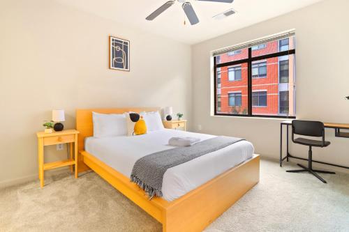 a bedroom with a bed and a desk and a window at Comfort & Convenience in Trendy Crystal City Loft in Arlington
