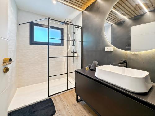 a bathroom with a tub and a shower and a sink at Modern 2 bedroom house, sleeps up to 6 in Saint-Didier-de-Formans