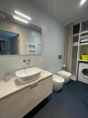 a bathroom with a sink and a washing machine at Casa vacanze Montaldo in Bordighera