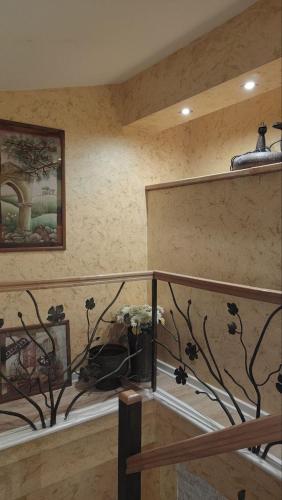 a room with a staircase with a painting on the wall at Rezevici AZUR in Budva