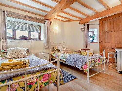 Un dormitorio con dos literas y una mesa. en 2 Bed in Looe TRERO, en Menheniot