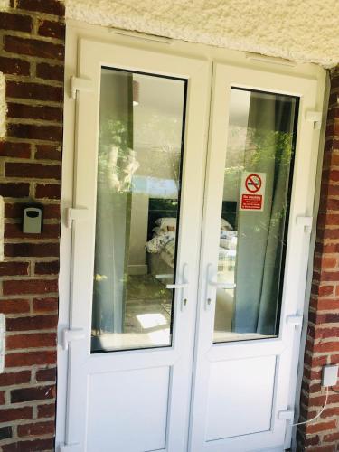a white door with two windows on a brick building at The Studio in St Austell