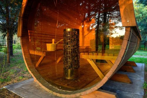 a reflection of a bench in a circular window at Dziupla House in Czarna