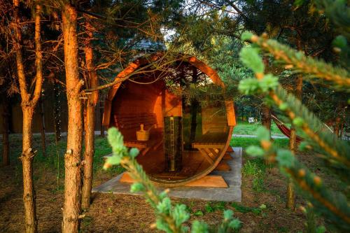 a tree house in a forest with a glass door at Dziupla House in Czarna
