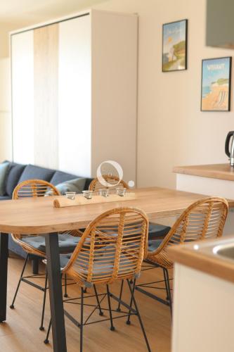a dining room with a wooden table and chairs at COC - Le Cocon des 2 Caps in Wissant