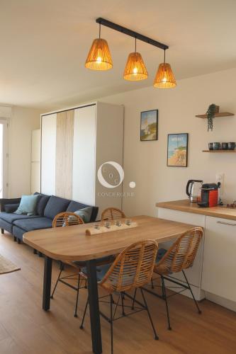 a living room with a table and chairs and a couch at COC - Le Cocon des 2 Caps in Wissant