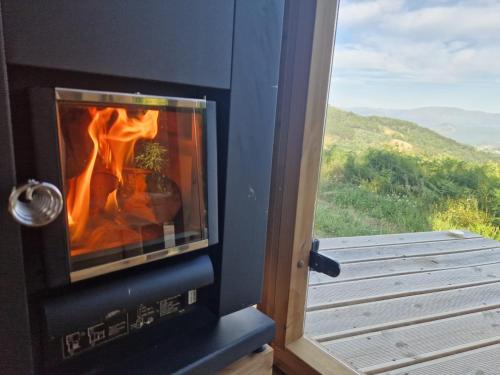 a fireplace with a view of a mountain at CASA DO SOL , Turismo Rural in Celorico de Basto