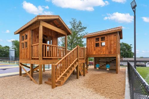 a wooden play house with a staircase and a playset at Lakefront Oasis - Amazing Views in Kimberling City