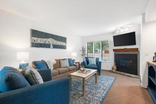 a living room with a couch and a fireplace at Lakefront Oasis - Amazing Views in Kimberling City