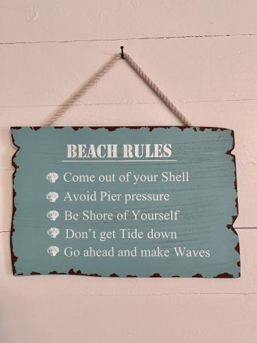 a sign that is hanging on a wall at Coastal Cottage in Port Saint Joe