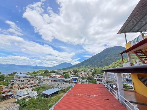 a balcony of a building with a view of a city at Hotel PENELEU in San Pedro La Laguna