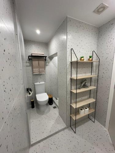 a bathroom with a toilet and a glass door at Christinas HOUSE in Kefalos