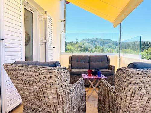 a porch with two chairs and a table with a view at Secluded Villa with Private Pool Almyrida in Almirida
