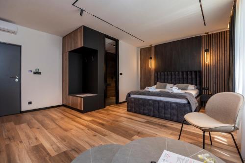 a bedroom with a bed and a table and a chair at Apartments AMALFI Old Town FREE Parking in Sarajevo
