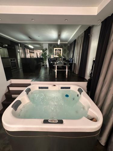 a jacuzzi tub in the middle of a room at B&M Jacuzzi Rezidencija SELF CHECK - IN in Vilnius