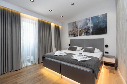 a bedroom with a bed with two plates on it at Apartments AMALFI Old Town FREE Parking in Sarajevo