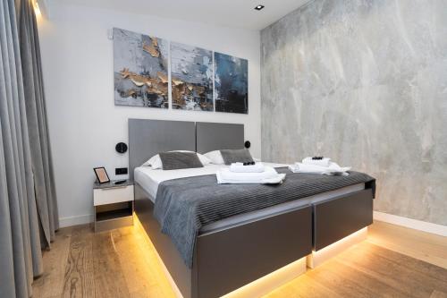 a bedroom with a large bed in a room at Apartments AMALFI Old Town FREE Parking in Sarajevo