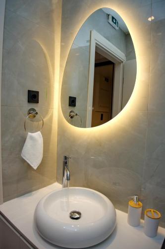 a bathroom with a white sink and a mirror at Blisséa in Piraeus