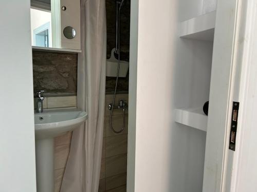 a bathroom with a sink and a shower at Vrisaki 81400, Lemnos Island in Mirina