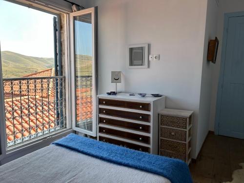 a bedroom with a dresser and a large window at Vrisaki 81400, Lemnos Island in Mirina