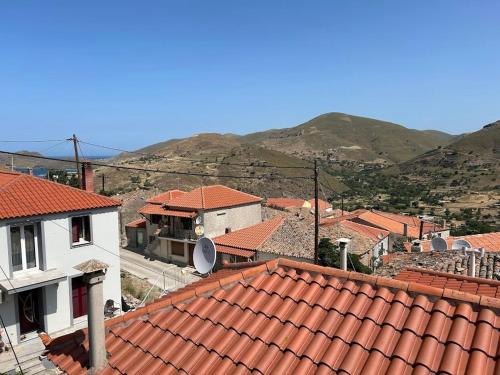 a town with red roofs with mountains in the background at Vrisaki 81400, Lemnos Island in Mirina