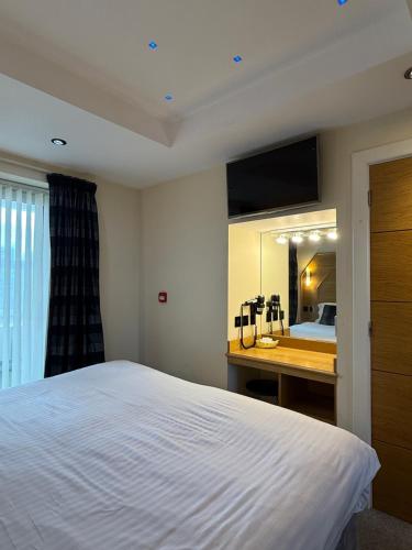Ένα ή περισσότερα κρεβάτια σε δωμάτιο στο Granada Apartments Queens Mansions