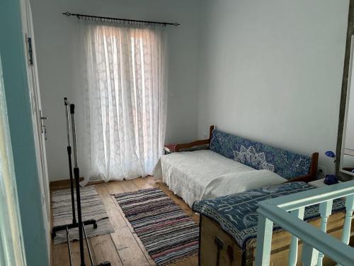a living room with a bed and a window at Vrisaki 81400, Lemnos Island in Mirina
