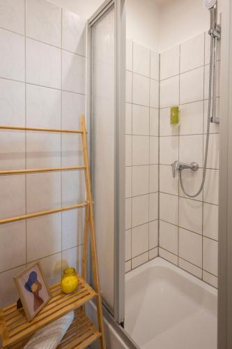 a bathroom with a bath tub and a shower at 4-room apartment in the heart of Chemnitz in Chemnitz