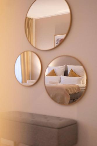 a bedroom with two mirrors on the wall with a bed at 4-room apartment in the heart of Chemnitz in Chemnitz