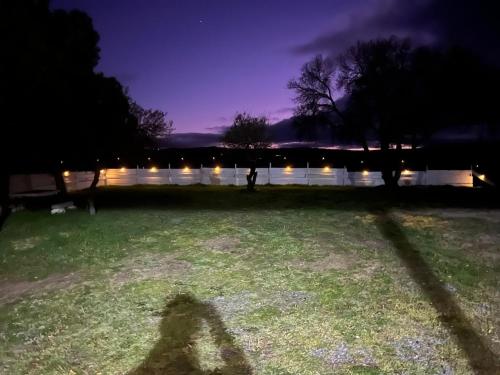 a shadow of a person standing in a field at night at House in nature with a spa and large garden 