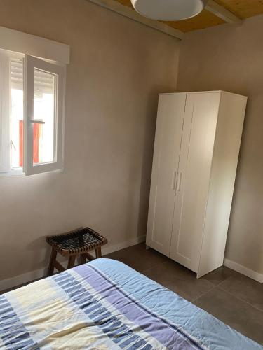 a bedroom with a bed and a cabinet and a window at House in nature with a spa and large garden 