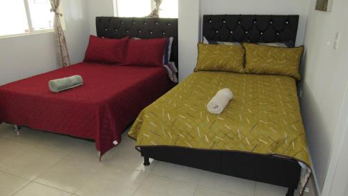 a bedroom with two beds with red and green sheets at Quinta Divina Providencia in Fusagasuga