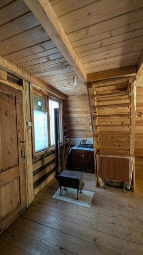 a room with a bench in a wooden house at House in forest in Gomi